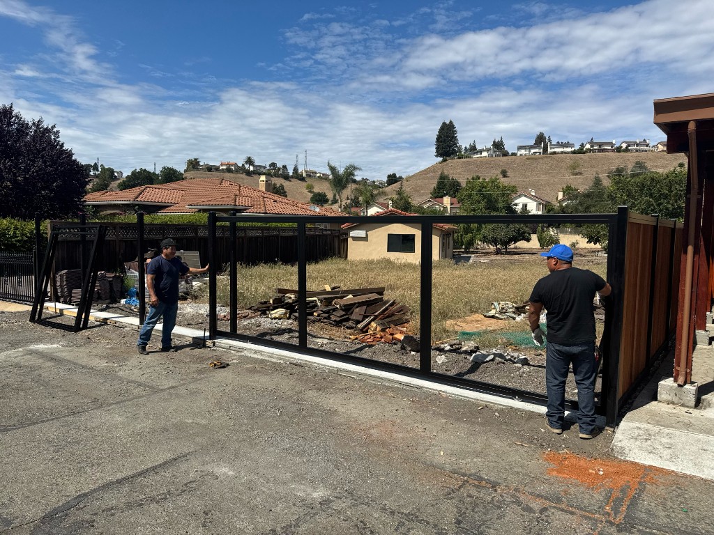 Steel sliding gate frame being positioned during fabrication in Fremont