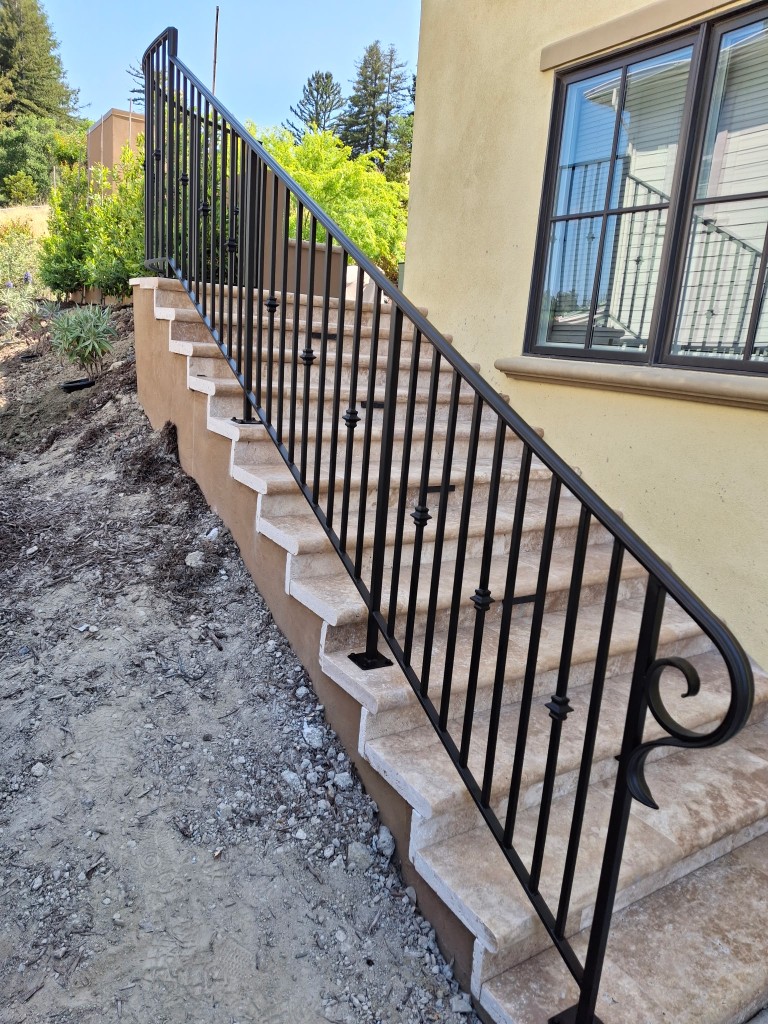 Close-up of wrought iron handrail scroll detail fabricated in San Jose